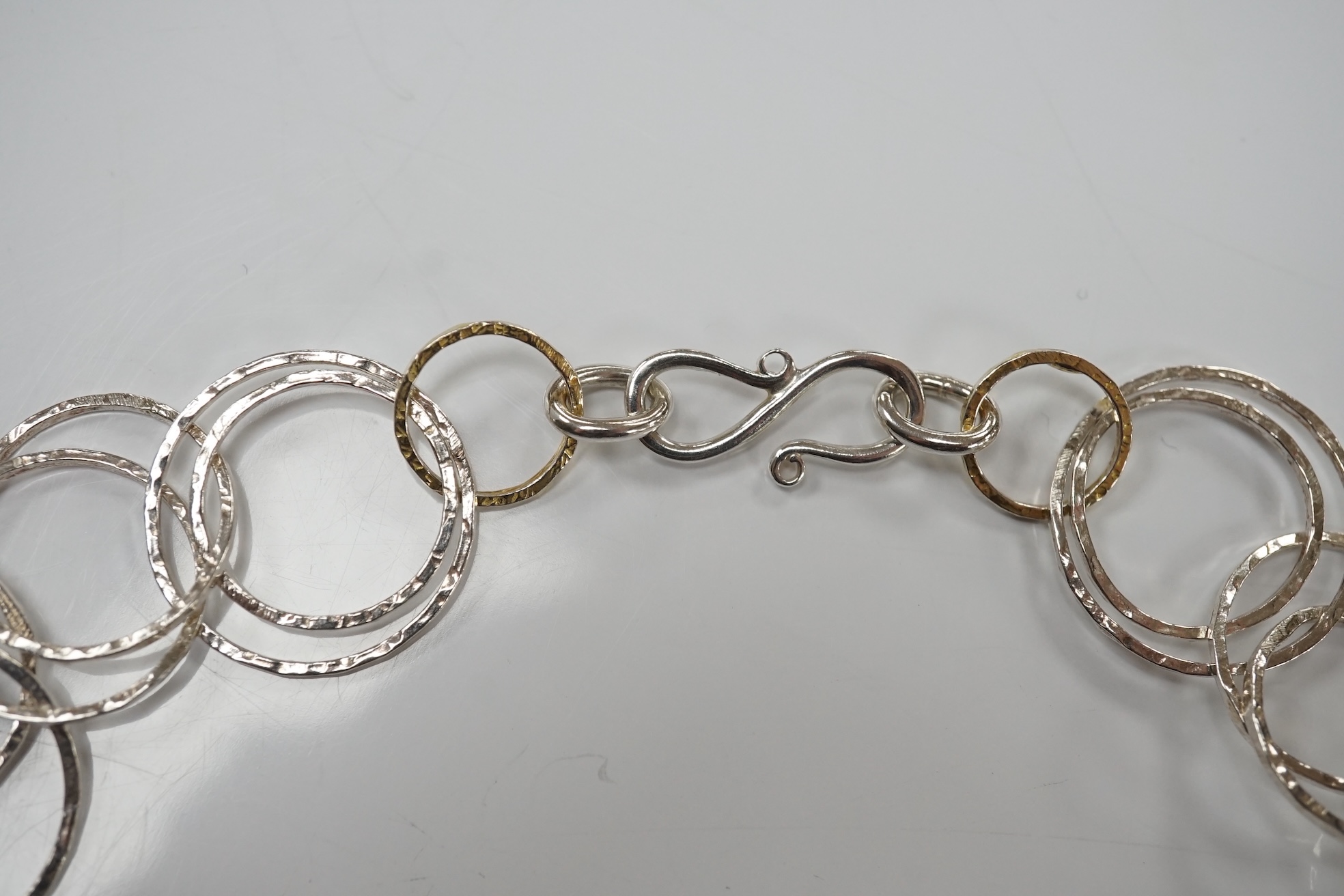 A modern Pruden & Smith silver and yellow metal hoop necklace and a 750 white metal and diamond set multi strand necklet retailed by Mappin & Webb. Condition - fair to good